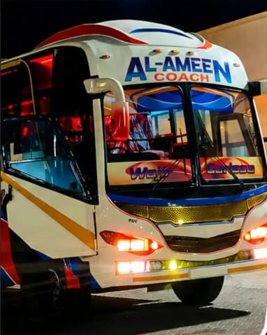 Al-Ameen Coach bus at night, ready for departure